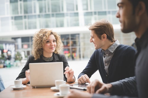 graphicstock-multiracial-contemporary-business-people-working-connected-with-technological-devices-like-tablet-and-laptop-talking-together-sitting-in-a-bar-finance-business-technology-concept_Hpyk5jdJ-