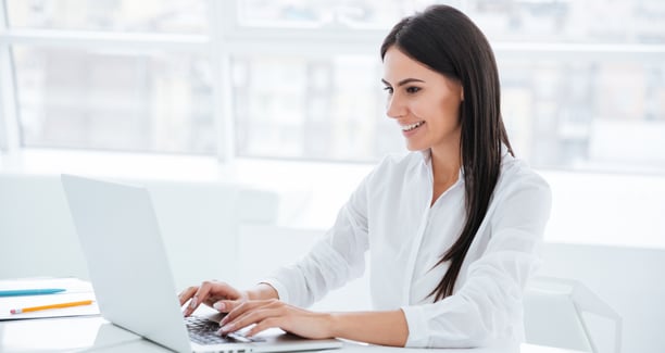 graphicstock-side-view-of-business-woman-using-laptop-and-sitting-by-the-table-in-office_B8hlvKv7_ne.jpg